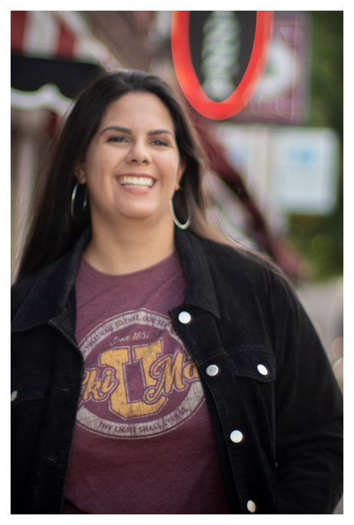 woman walking down the street with maroon shirt