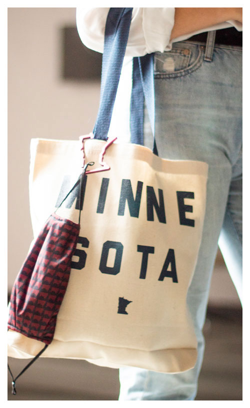 woman holding minnesota tote and mask