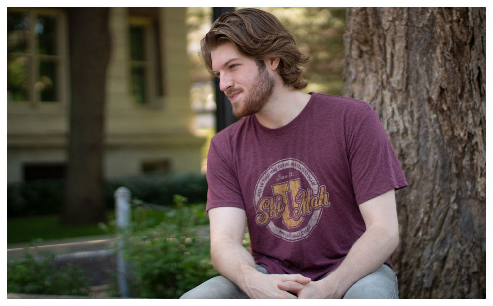 student sitting by tree