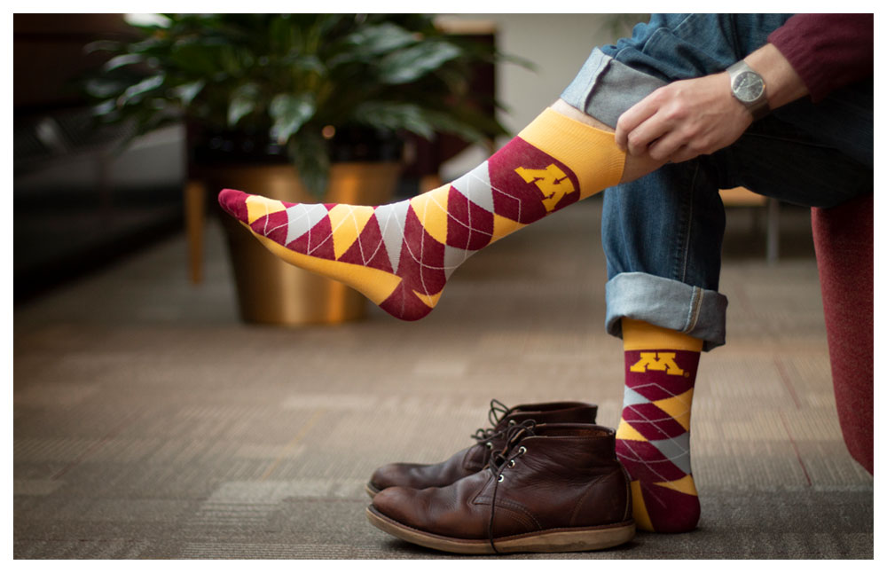 lifestyle photo of man putting on argyle socks
